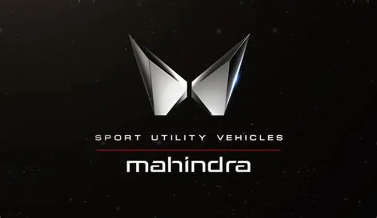 Mahindra logo with metallic butterfly-like emblem and the words SPORT UTILITY VEHICLES and mahindra beneath it, set against a dark background.