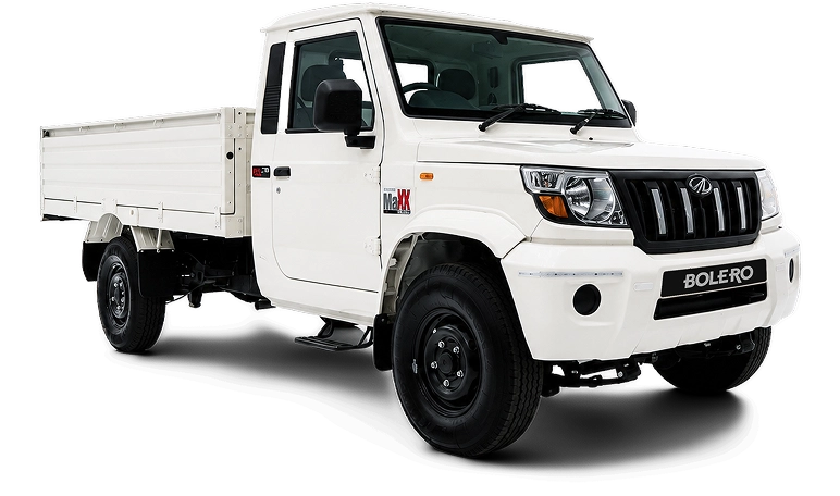 White Mahindra Bolero flatbed pickup seen from the front-right, ready for hauling cargo.